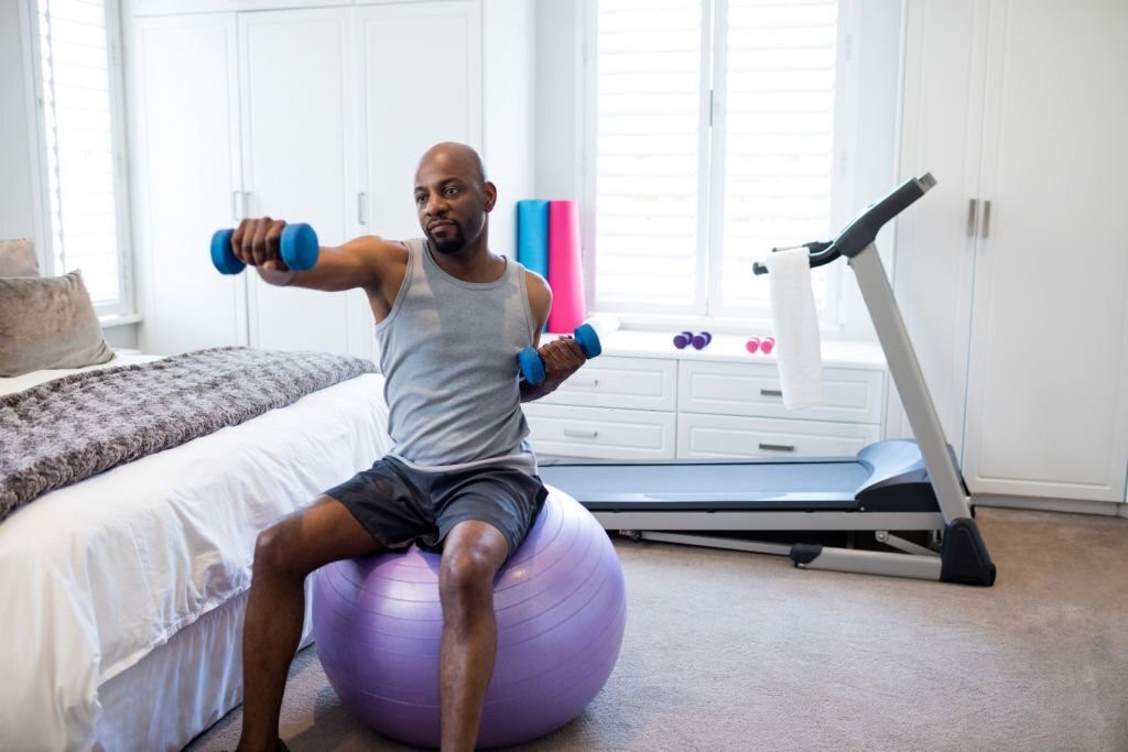 A Man Doing Exercise in Living Room Gym