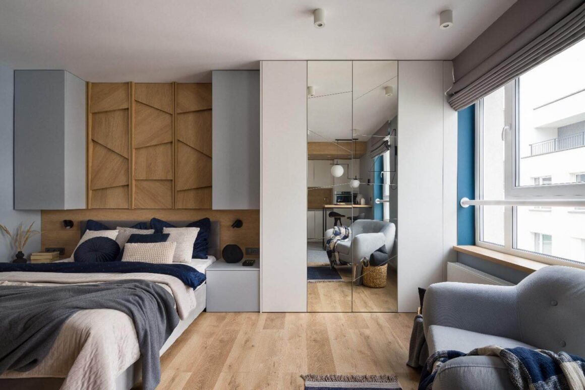 A Studio Apartment has a Large Mirror